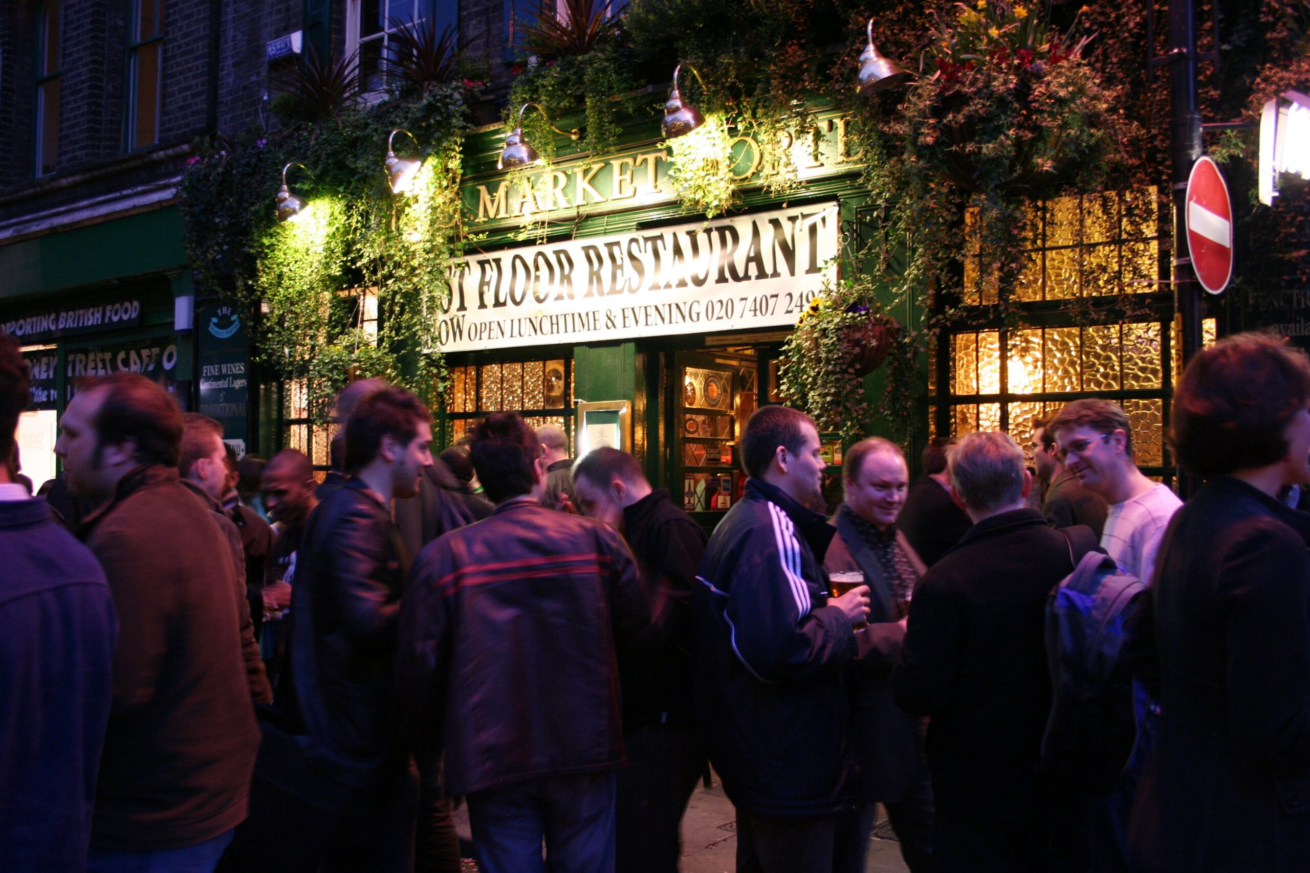 people outside a bar at night